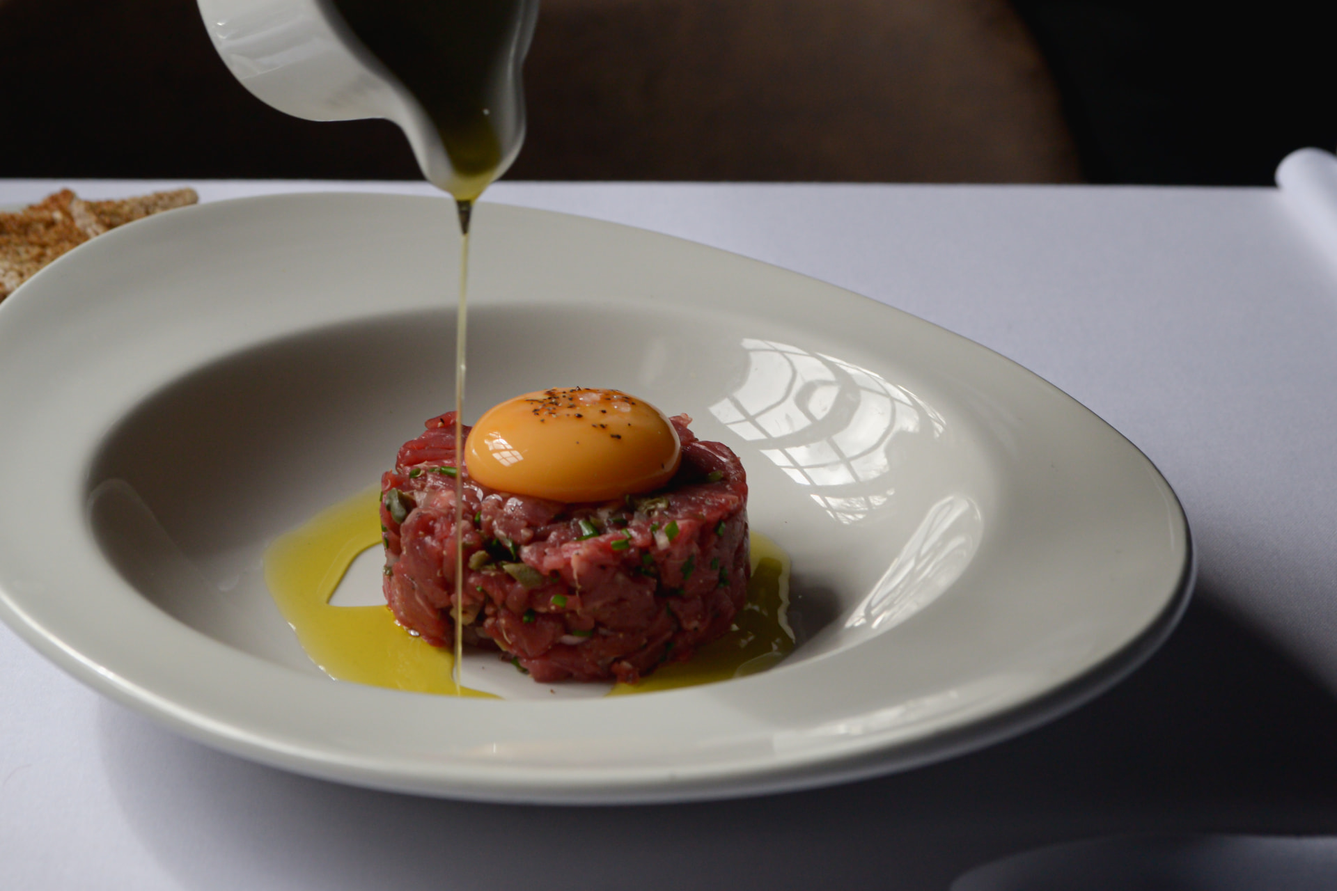 Beef tartare with olive oil poured over