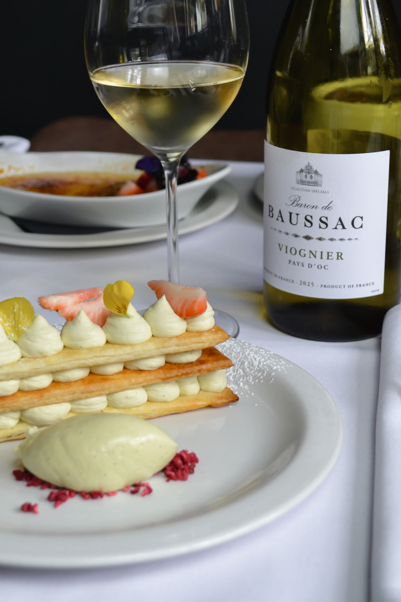 Mille-feuille with vanilla cream and a glass of white wine