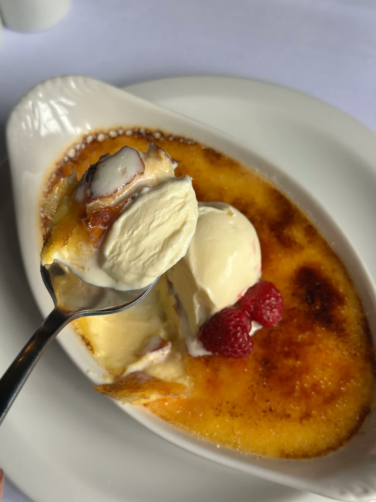 Crème brûlée with ice cream and raspberries